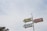 A vintage-style signpost features three directional arrows labeled 'SELF-SERV', 'DISCOUNT', and 'GAS', set against a cloudy sky. The signs are attached to a vertical pole.