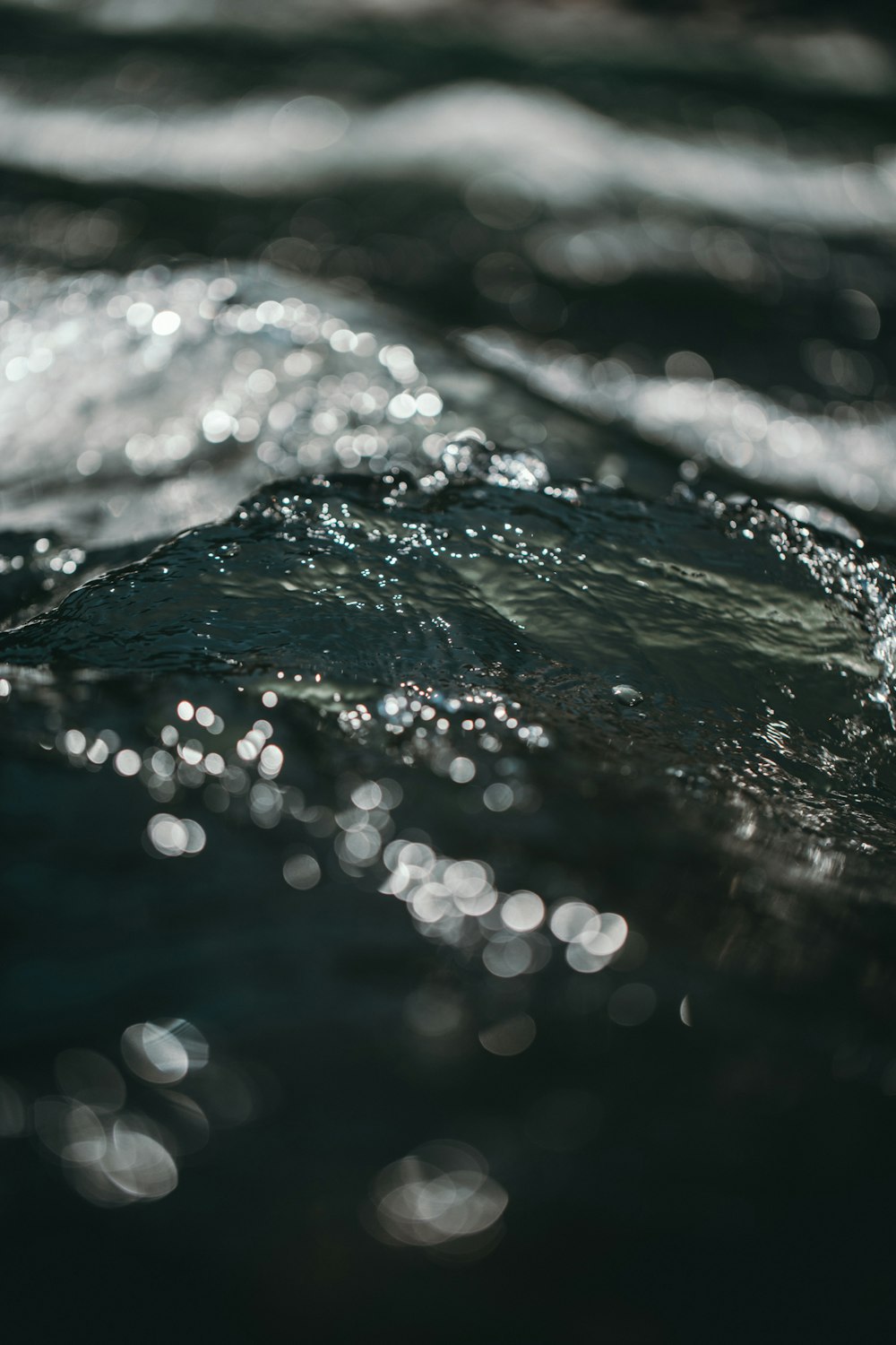 bokeh photography of splashing blue water