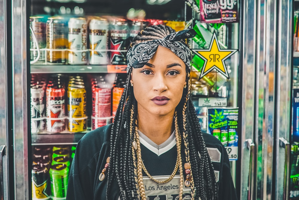 woman standing beside vending machine