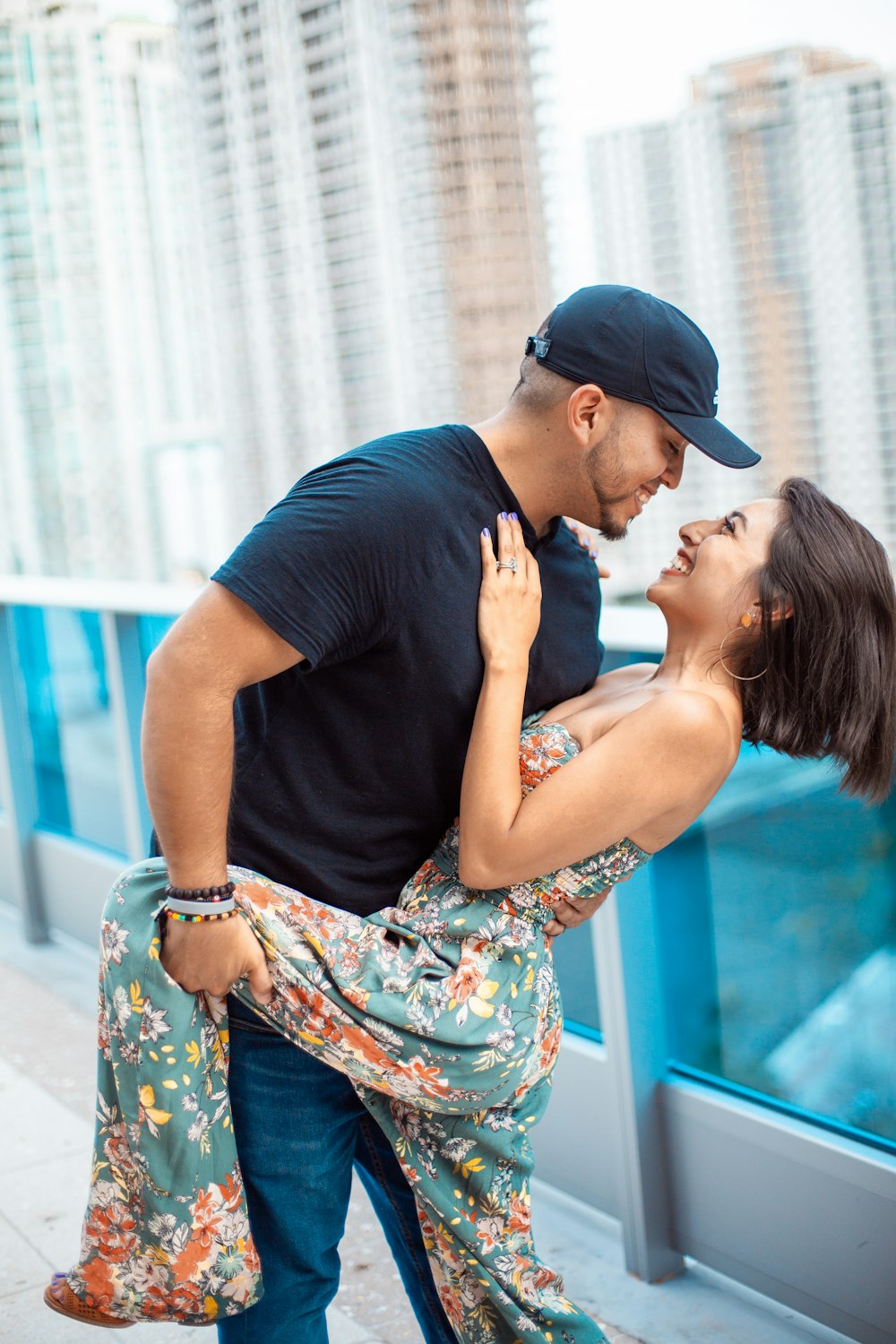 man holding girl while laughing