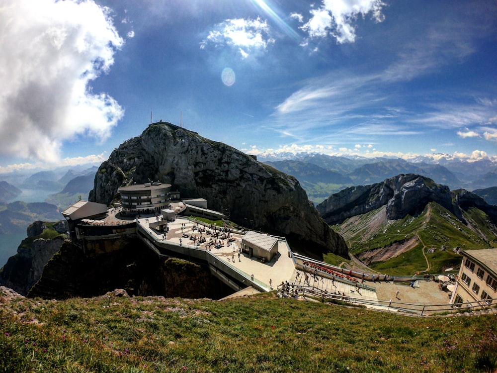 concrete building on mountain under cloudy sky