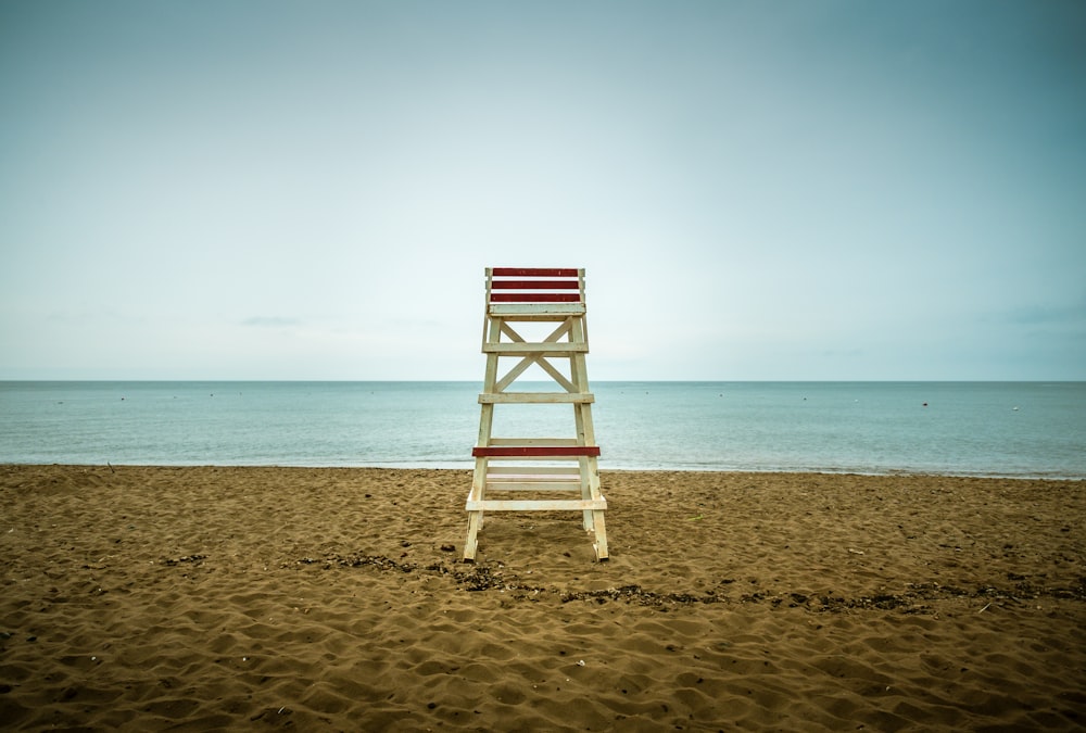 beige wooden lifeguard seat on shore