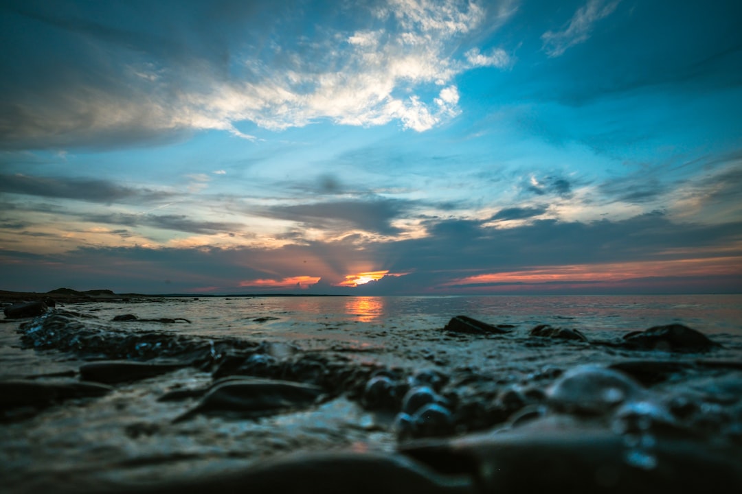 landscape photo of body of water during sunset