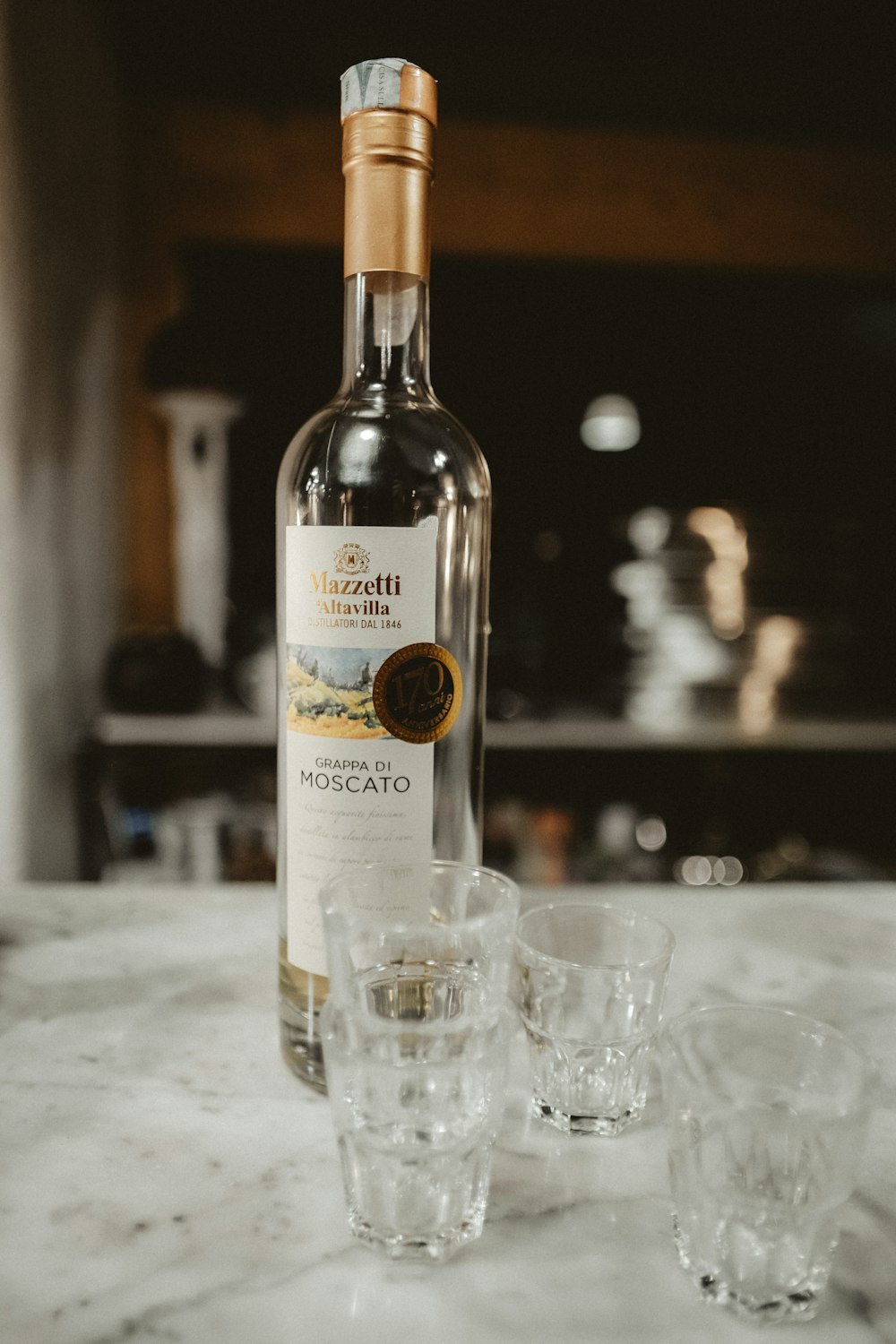 Mazzetti Altavilla moscato bottle with shot glasses on table