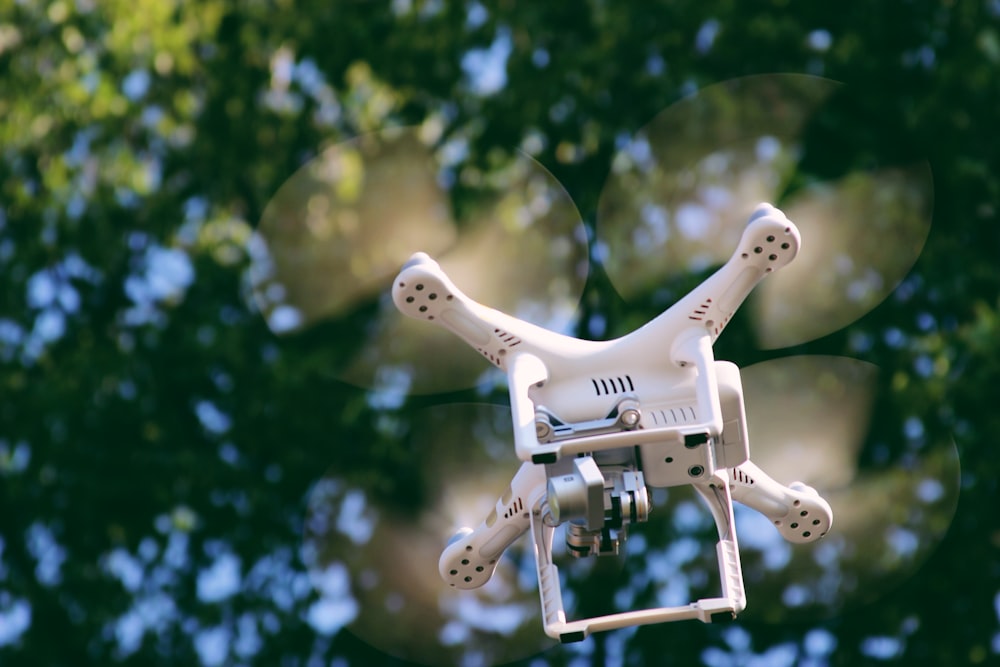 selective focus photography of white quadcopter