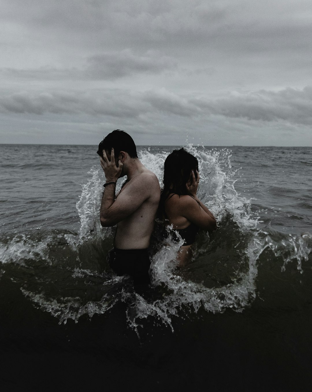 time lapse photography of couple standing on body of water