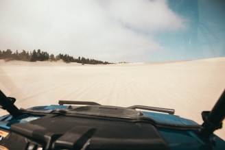 A panoramic view of Rajasthan’s desert landscape with a taxi cruising along.