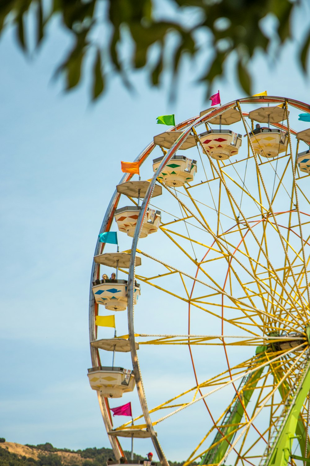 selective focus photography of yellow and green Ferris wheel