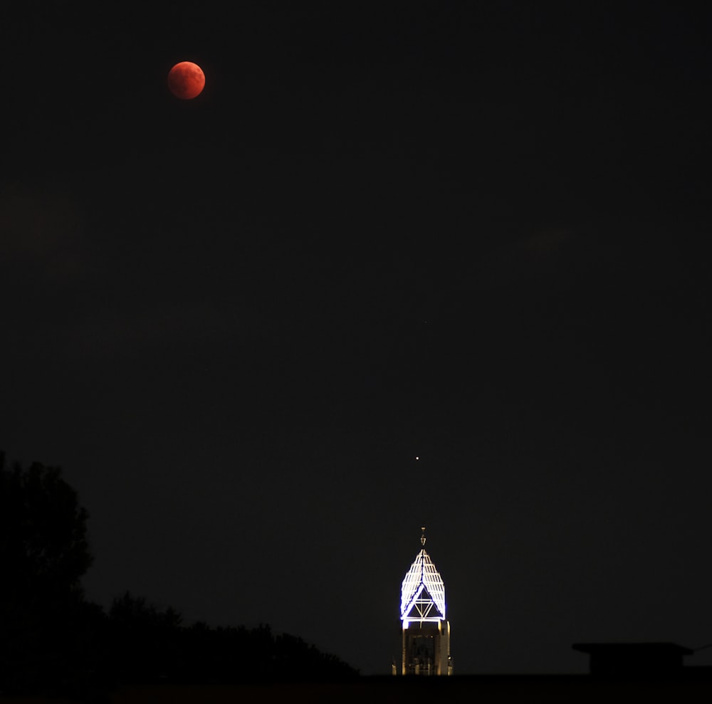tower under red moon