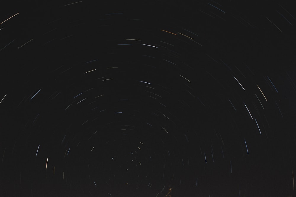 the night sky is filled with star trails