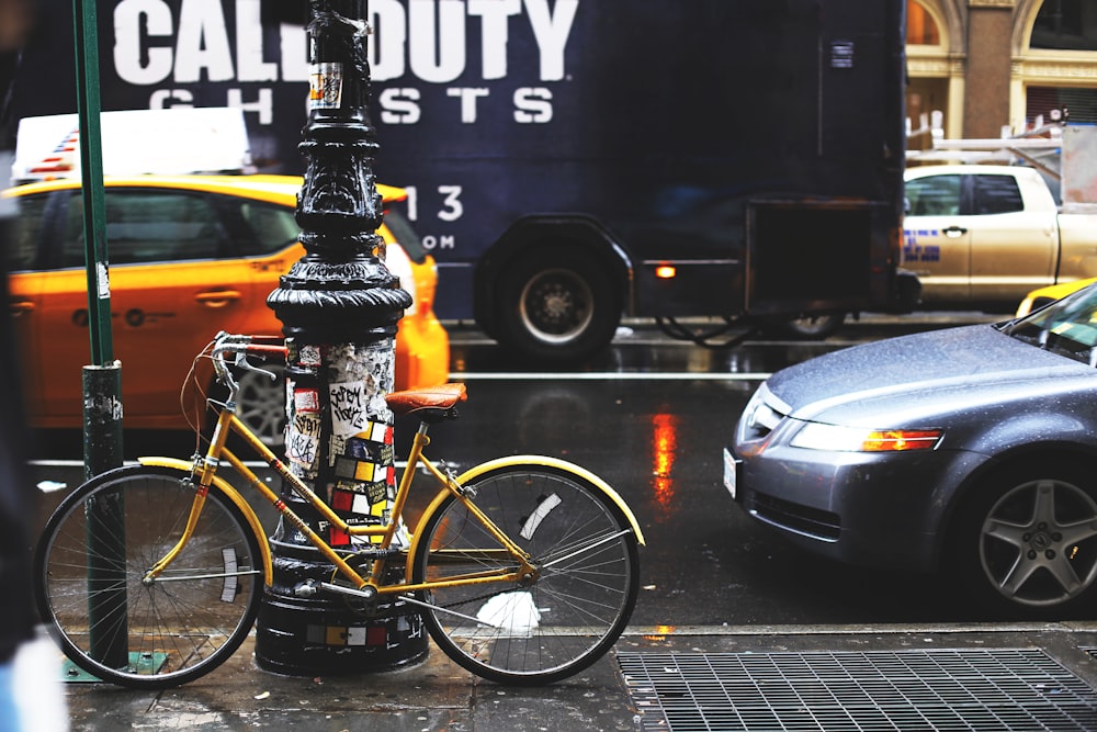 yellow bicycle parking near post