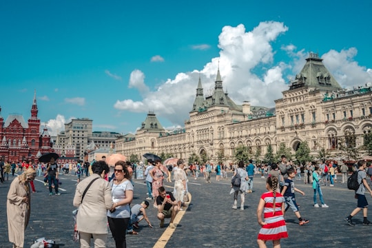 A group of travelers happily exploring a vibrant city square.