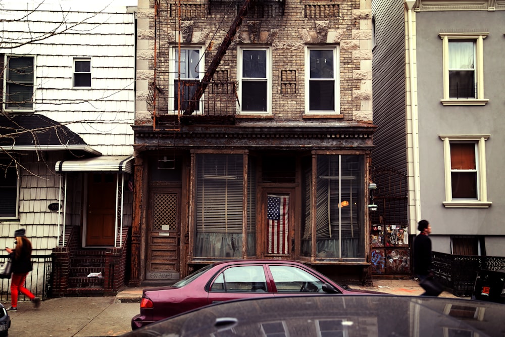 red sedan parked outside building