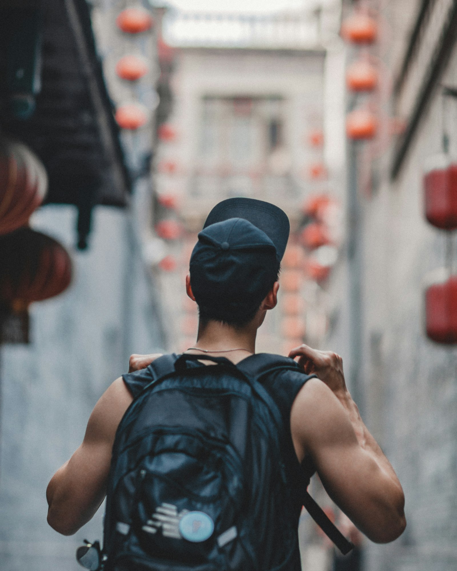 Canon EF 85mm F1.2L II USM sample photo. Man holding black backpack photography