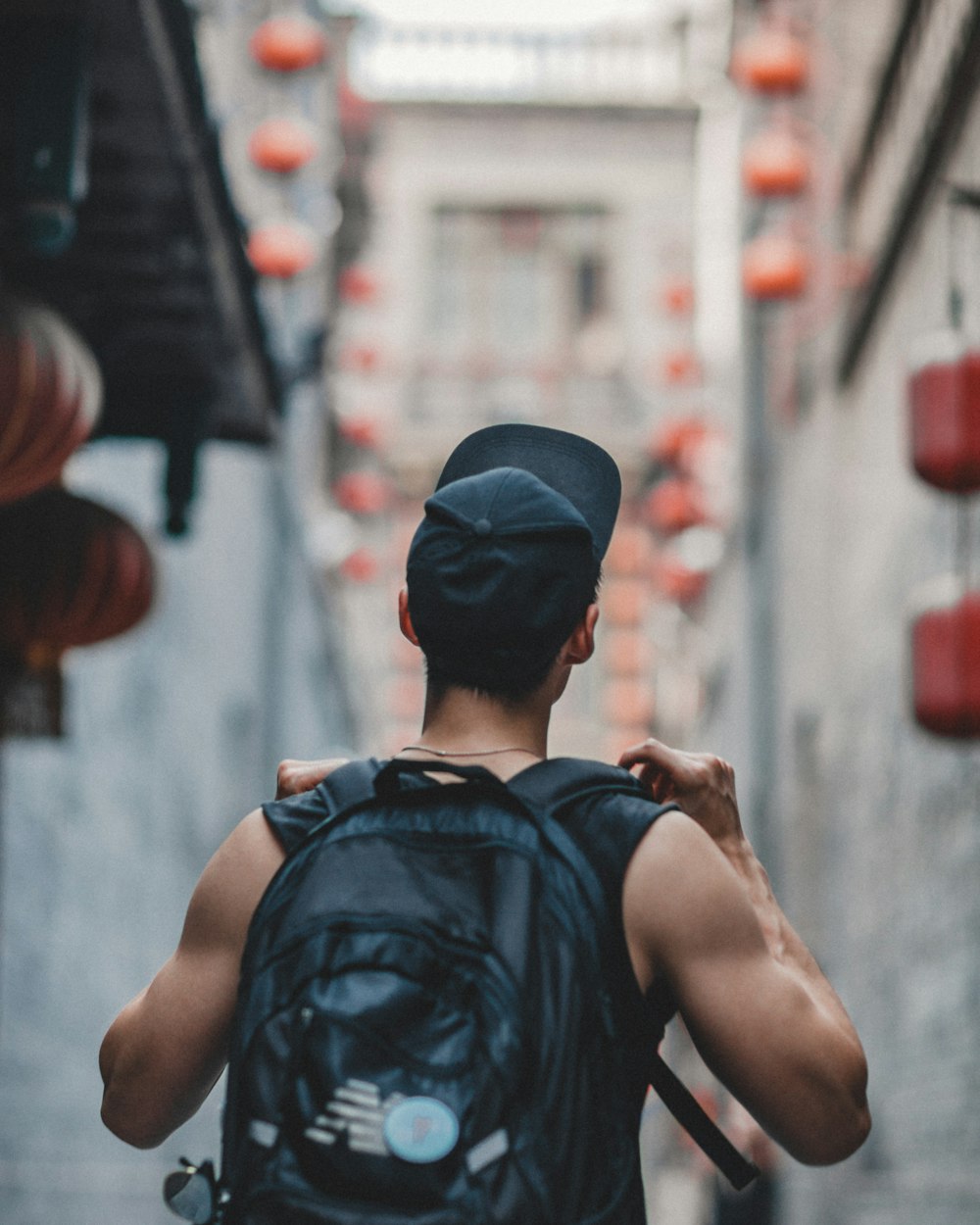 man holding black backpack