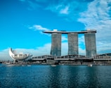 gray concrete buildings near body of water