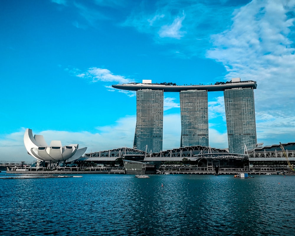 gray concrete buildings near body of water