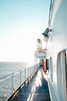 A quiet morning scene of a ship’s pool area with lounge chairs and soft morning light.