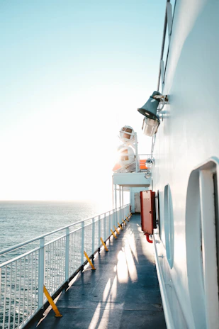 A compact portable air conditioning unit installed on a ship's deck under bright sunlight.