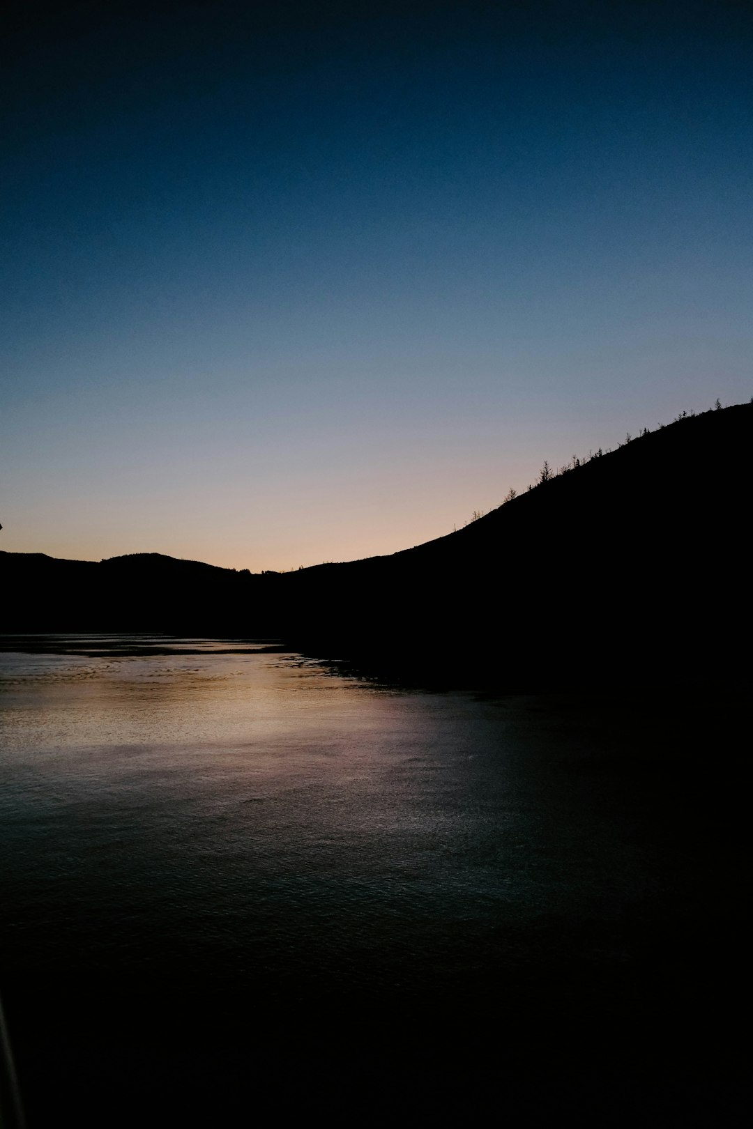 mountain and body of water at golden hour