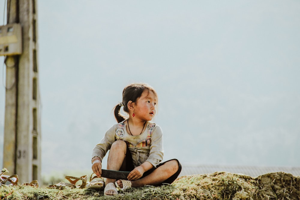 girl sitting on grasses