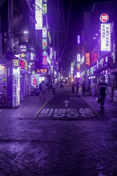 A vibrant street in Seoul lit with neon signs blending traditional Korean motifs and K-pop visuals.