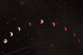 A sequence of lunar eclipse phases across a dark starry night sky