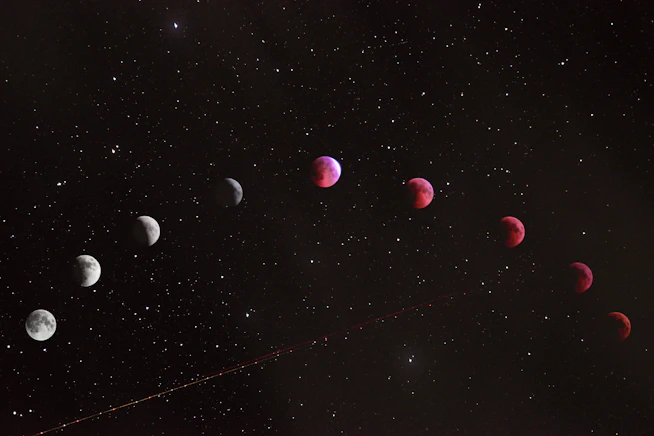 A sequence of lunar eclipse phases across a dark starry night sky