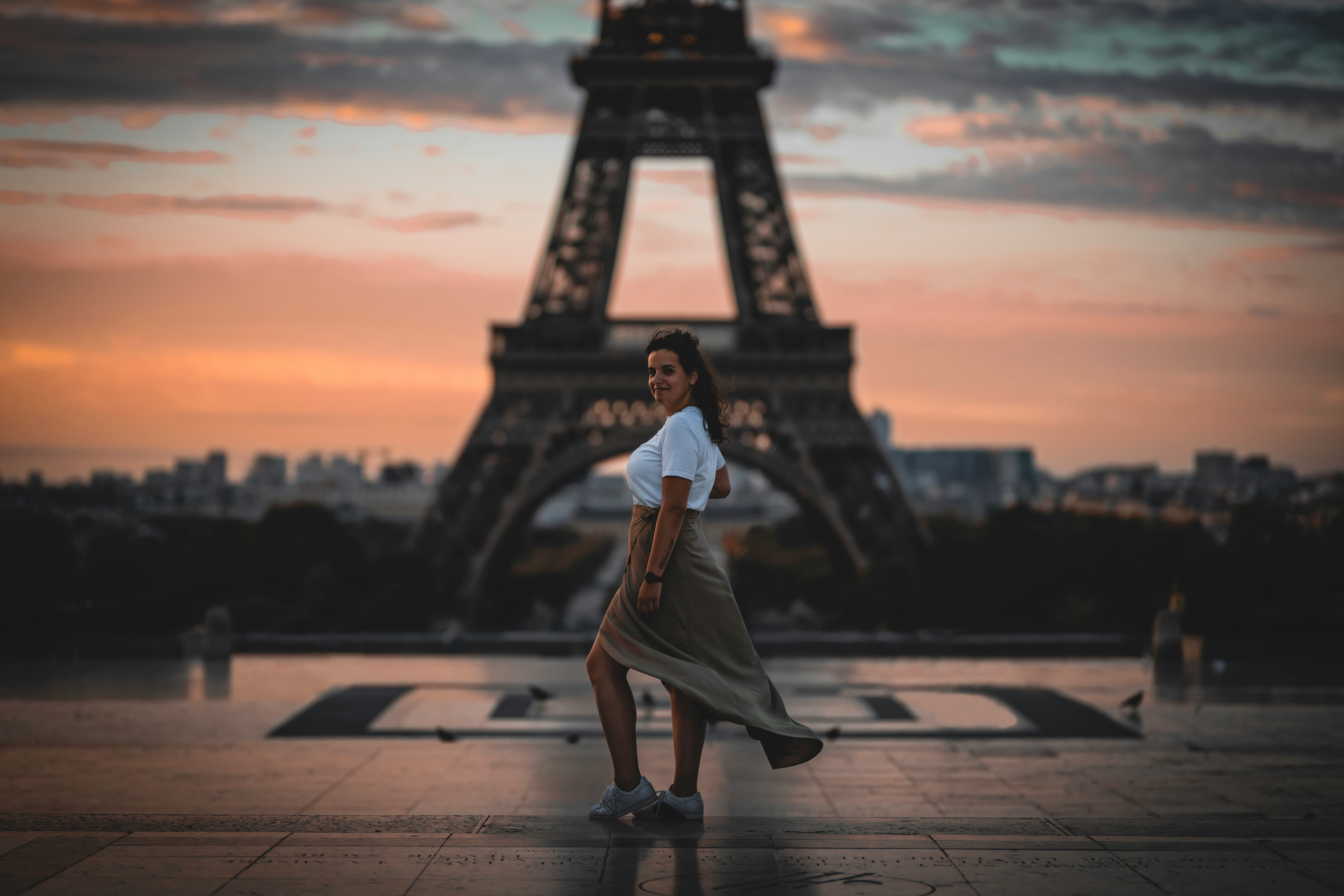 selective focus photography of woman standing in front of Eiffel Tower, Paris