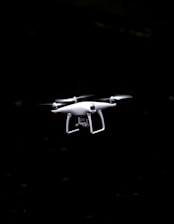 white and black quadcopter drone