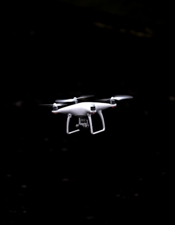white and black quadcopter drone