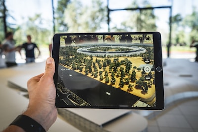 person holding black iPad