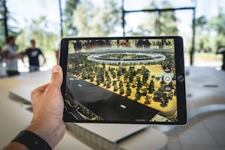 person holding black iPad watching virtual tour