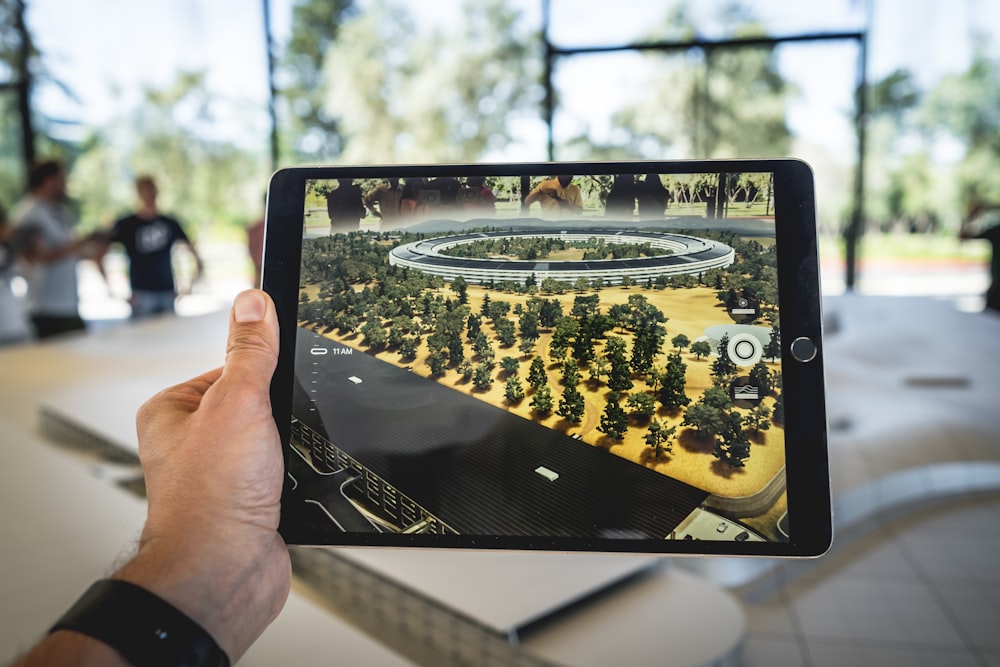 person holding black iPad