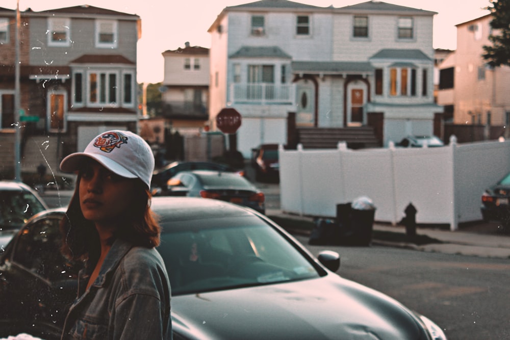 woman in front of black car