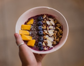 person holding bowl with food