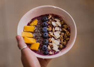 person holding bowl with food