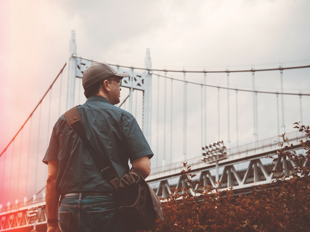 man standing near bridge