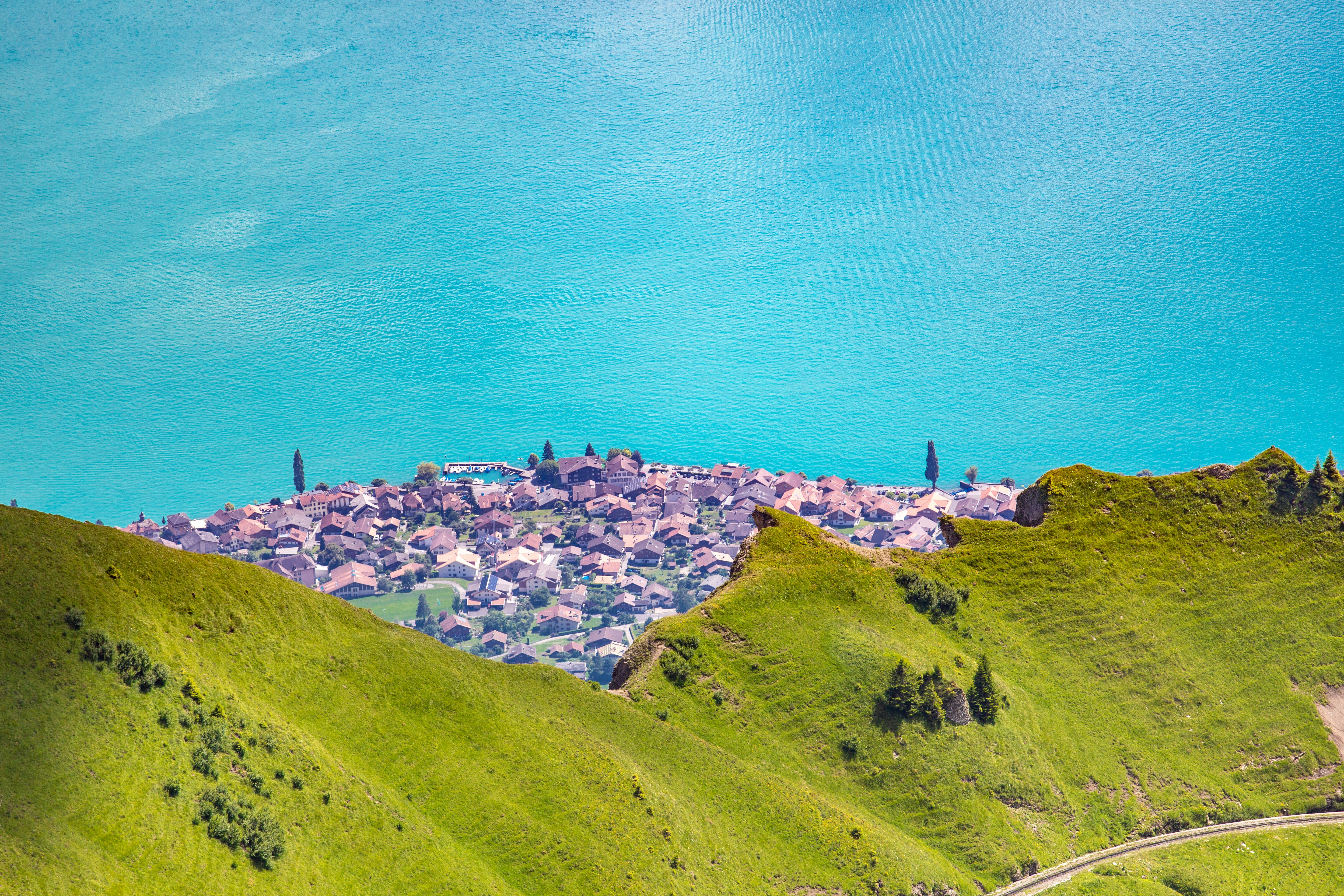 aerial photography of houses above green mountain