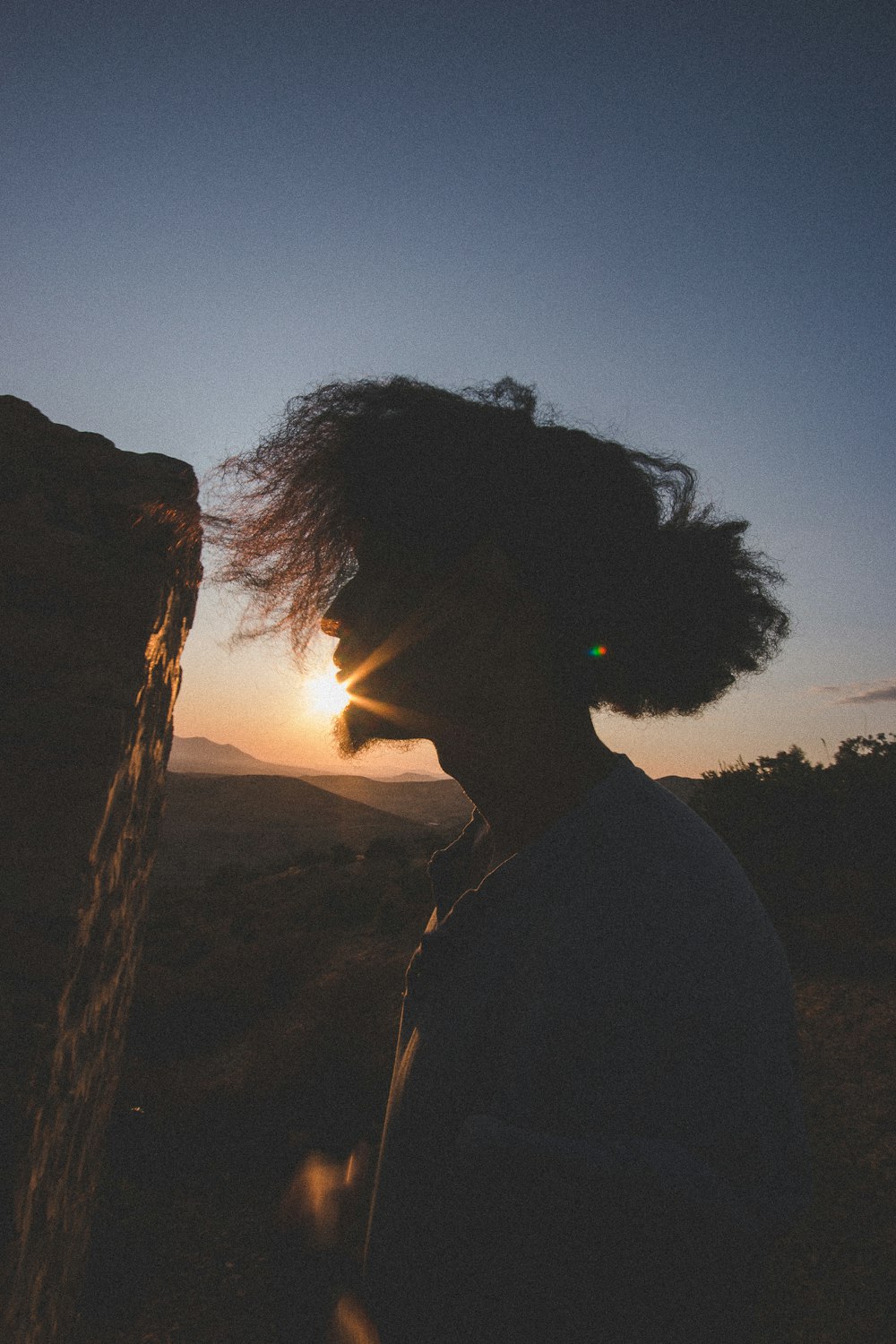 silhouette of person near cliff