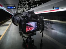 black canon dslr camera on black tripod