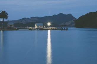A serene lakeside property with a dock and small boat under a sunset sky.