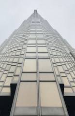 low angle photography of grey glass building