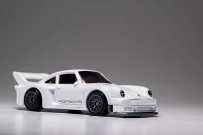 A sleek blue sports car scale model with detailed rims and headlights