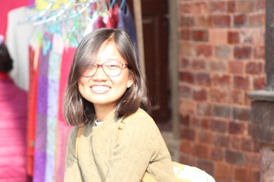 A friendly team member arranging stylish merchandise with a welcoming smile.