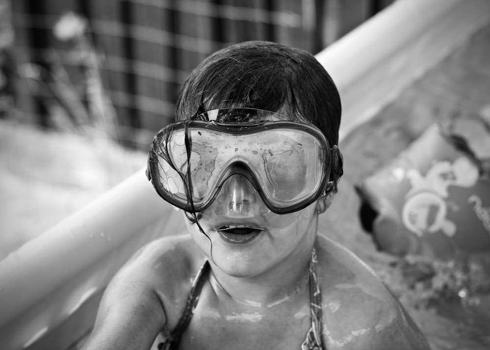 grayscale photography of girl wearing swimming goggles