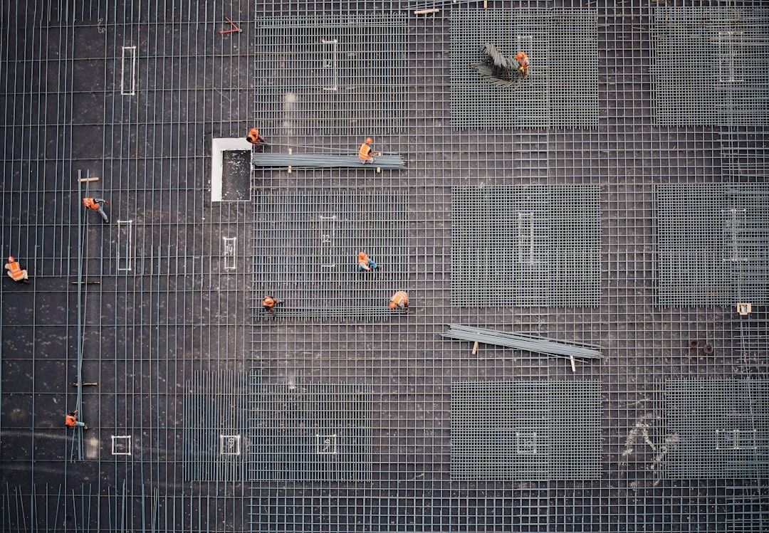 aerial photo of people in park at daytime, A photo of a construction site taken from a higher building.