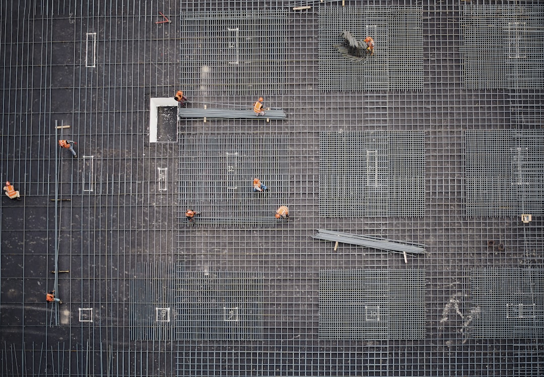 aerial photo of people in park at daytime, A photo of a construction site taken from a higher building.