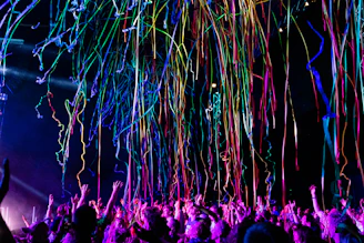 A vibrant celebration scene with confetti, gift boxes, and happy people holding prize tickets.