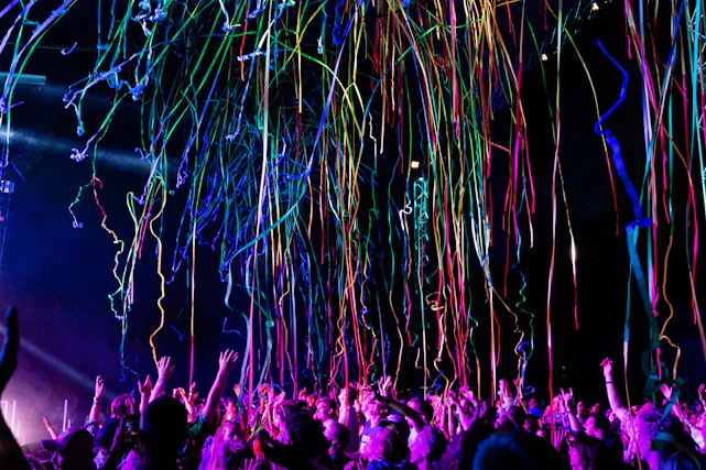 A vibrant celebration scene with confetti, gift boxes, and happy people holding prize tickets.